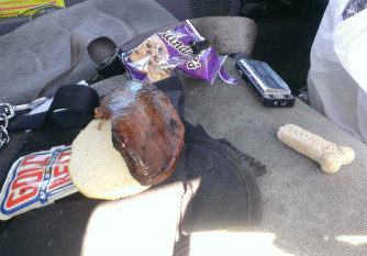 Front seat of the truck with the half of the sandwich Charlie didn't eat laying untouched.