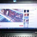 Laptop showing YouTube videos about washing machine repair